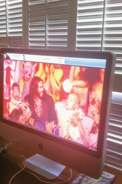 Russell Brand performs at the Olympics as shown on an iMac computer screen.