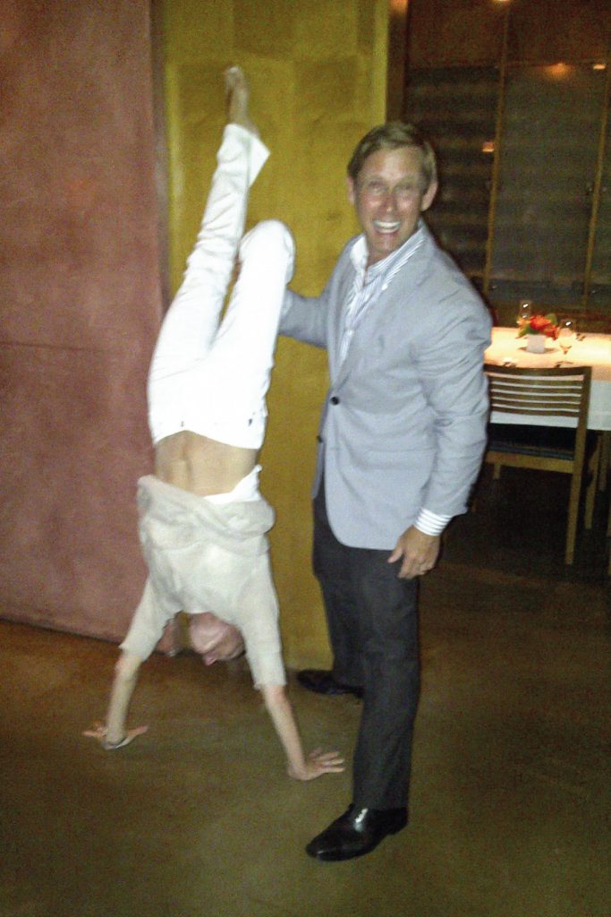 Lady Thérèse performing a hand stand outside the restaurant.